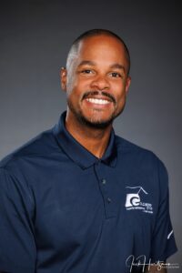 upper body and head of man smiling wearing polo shirt with Goldberg Logo